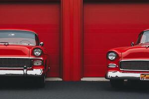 Two classic cars parked next to each other photo