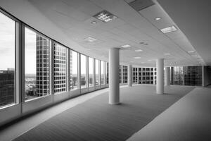 Black and white photo of empty office building with large windows