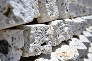 A close up of a wall of white stone photo