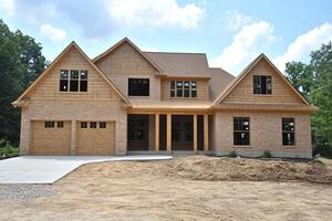 A large home with a large garage and a large driveway photo