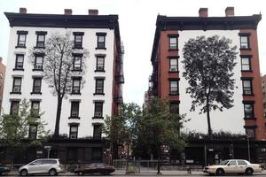 Two buildings with trees painted on them photo