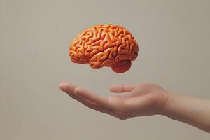 Hand holding floating brain representing mental health and intelligence photo