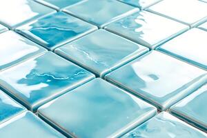 Shiny light blue square tiles creating repeating pattern photo