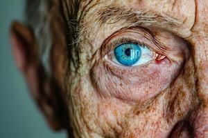 Close up of senior man showing wrinkles and blue eye photo