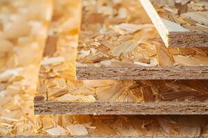 Close up of stacked oriented strand board showing wood chips and layers photo