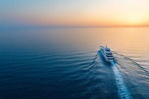 Luxury yacht sailing on calm sea at sunset, aerial view. photo