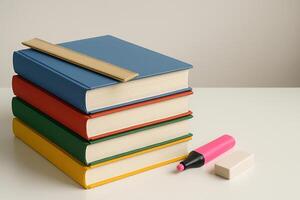 stack of books with pencil and eraser on white background photo
