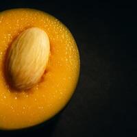 a piece of fruit with a seed inside photo