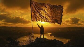 A man holding a large flag on top of a mountain photo