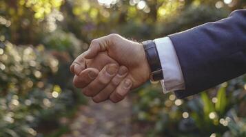 A man in a suit holding his hand over a garden photo