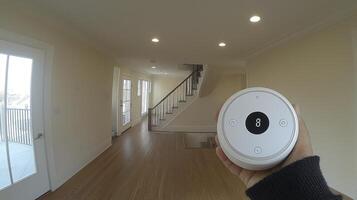 A person holding a remote control in a hallway photo
