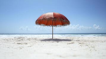 A red umbrella on a sandy beach photo