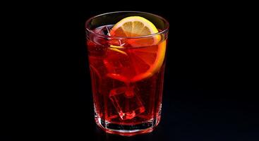 A red drink with a slice of lemon on top photo