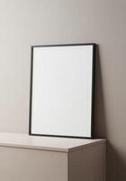 Blank frame mockup on a table against a wall photo