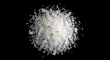 A pile of shredded coconut on a black background photo