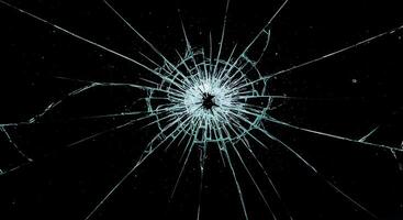 A broken glass window with a black background photo