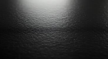 A black surface with a light shining on it photo