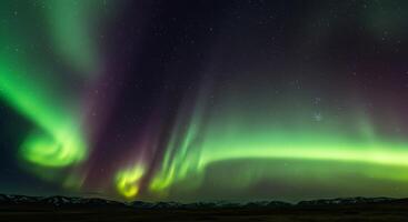 The aurora borealis is seen over the mountains photo
