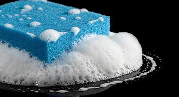 A blue sponge is being covered with soap photo