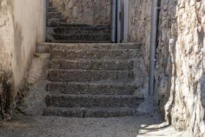 Ancient Stone Stairs Between Rustic Buildings photo