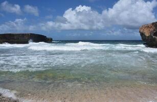 Coastal Tides with Waves Rolling Under Cloudy Skies photo