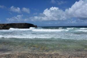 Waves Crashing and Rolling Ashore in Aruba photo