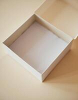 An empty white box on a beige background photo