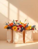Three paper bags with flowers on a table photo