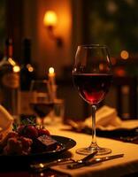 A table with a glass of wine and a plate of food photo