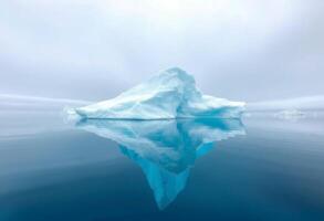 Iceberg in the ocean with fog and clouds photo