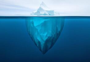 An iceberg floating in the ocean photo