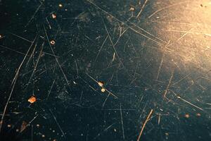 Close-up view of a dark surface with scratches and marks. photo