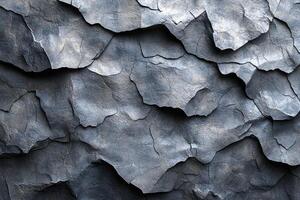 Close-up view of textured dark gray stone surface. photo