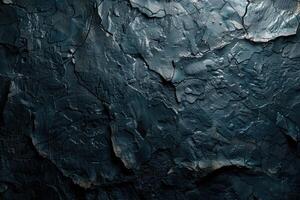 Close-up view of dark textured surface with deep cracks. photo