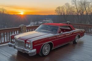 Classic car parked on a deck at sunset. photo