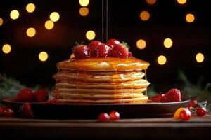 Stack of pancakes with syrup and strawberries on a plate photo