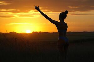 Silhouette of a person at sunset over a field. photo