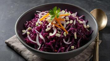 A bowl of red cabbage salad with carrots and onions photo