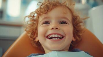 A young boy smiles while sitting in a dental chair photo