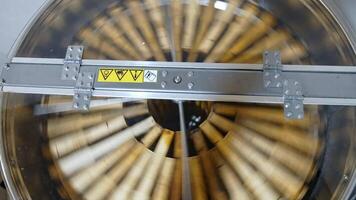 Honey extractor. Centrifuge with frames spinning inside and pumping honey. Industrial equipment to extract fresh honey from honeycombs. Top view. video