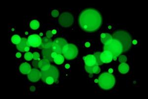 Green glowing bubbles on a black background vector