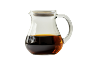 A glass pitcher filled with dark liquid, showcasing its elegant shape and handle. png
