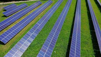 Solar power station on field. Background of innovative sunny batteries in environment. Flight over rows of long photovoltaic solar panels. Clean alternative energy. video