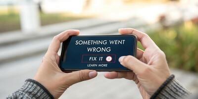 Someone is holding a smartphone with something wrong on it photo