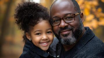 A man and a little girl smiling for the camera photo