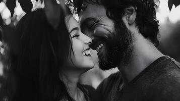 A man and woman are smiling together in front of a tree photo