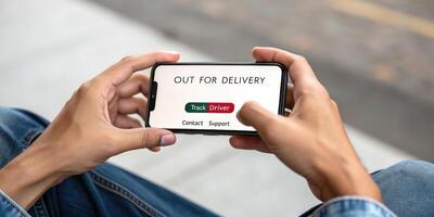 Out for delivery concept on smartphone photo