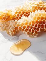 Minimalist flat lay of broken honeycomb cluster with honey drizzle photo