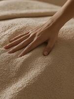 Close up of hand gently pressing soft textured fabric for relaxation and comfort photo