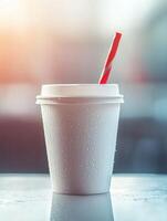 Refreshing beverage concept with disposable cup and red straw for summer photo